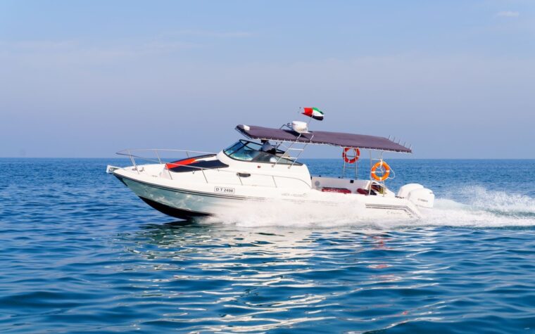31ft mini-yacht cruising off Dubai with the shaded hardtop up