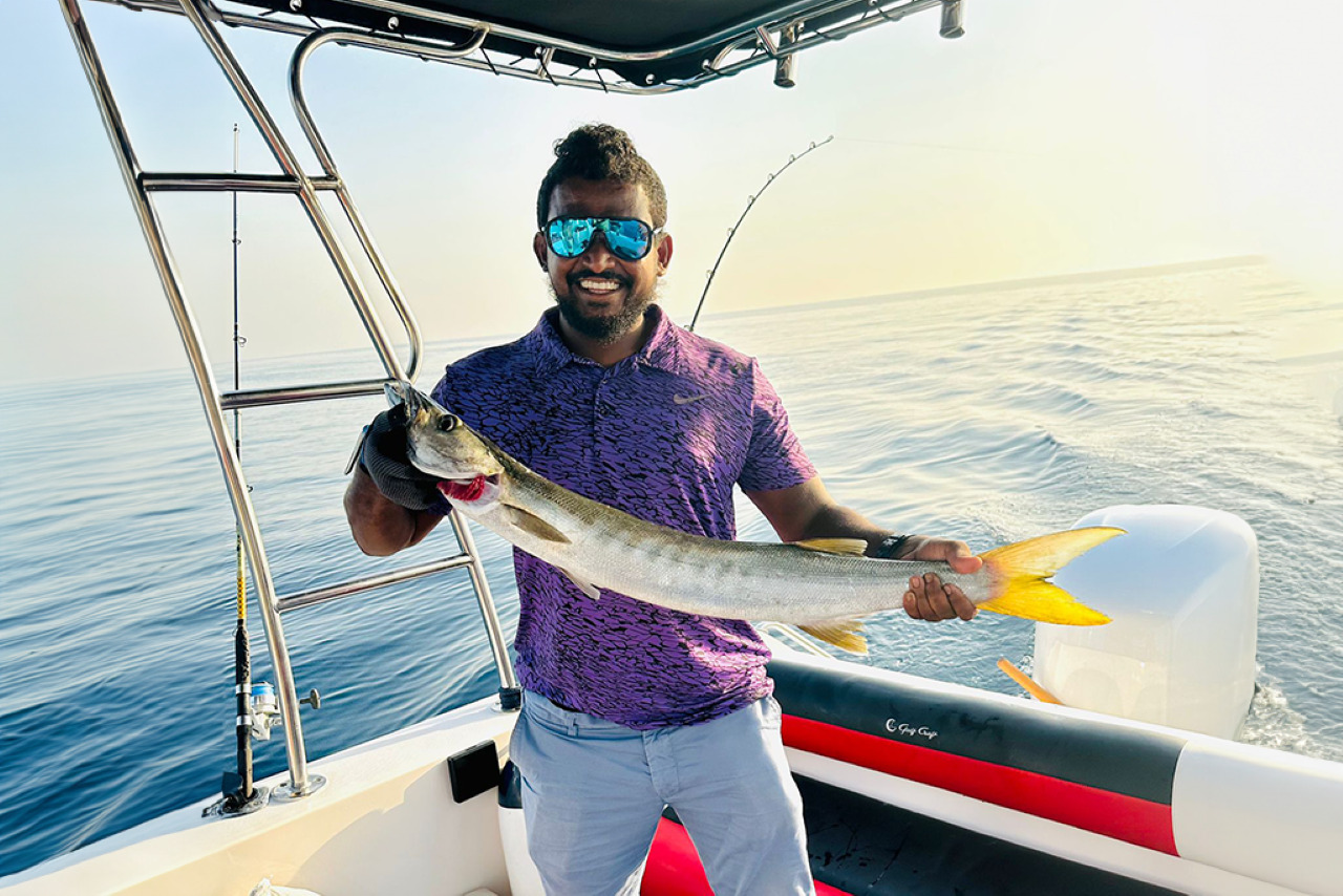 Angler holding a queenfish caught on a Sea King deep sea fishing trip off Dubai
