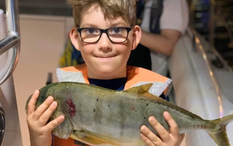 Child holding a fish caught on a Sea King deep sea fishing trip off Dubai