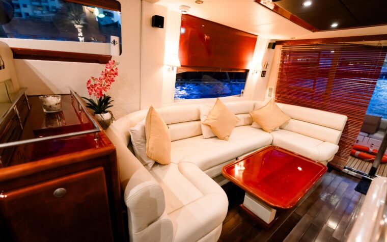 Air-conditioned saloon and dining table aboard the Dubai dinner cruise yacht