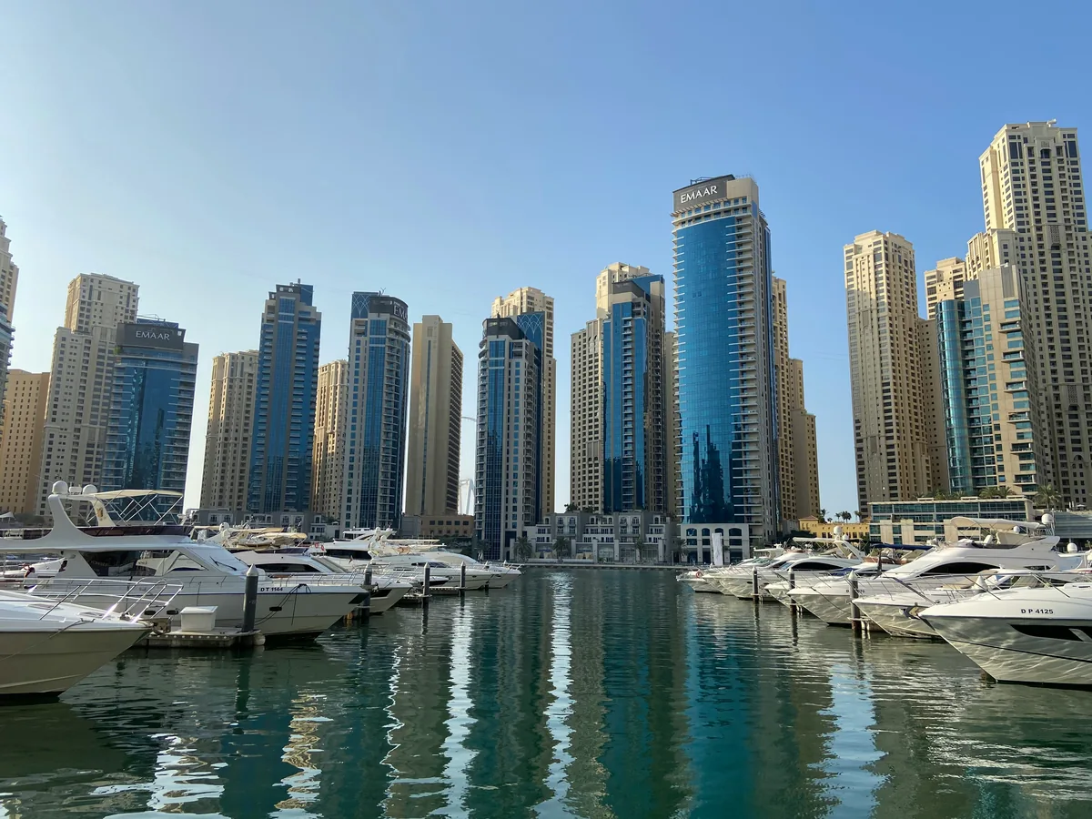 Dubai Marina yacht rental — private yachts docked in Dubai Marina with the Emaar skyline behind