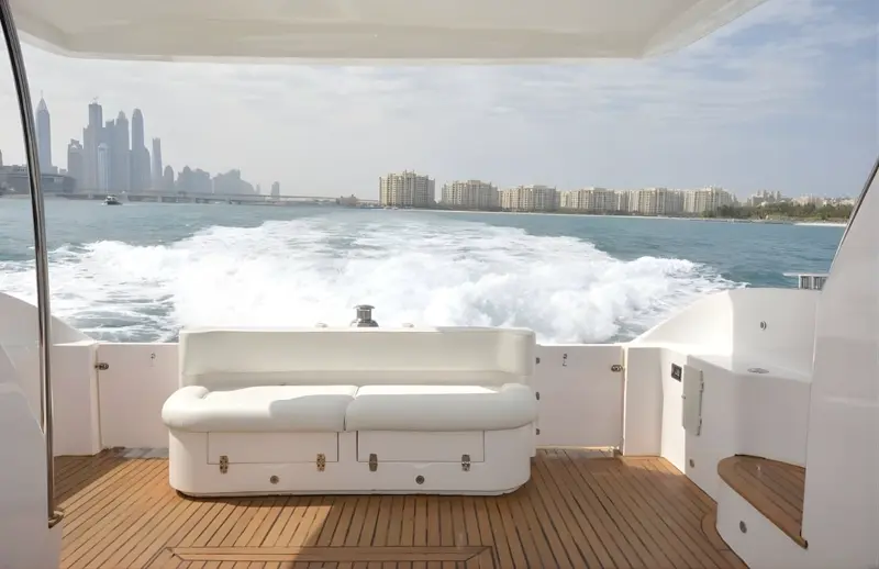 Luxury yacht rear deck with Dubai skyline and Burj Khalifa on the horizon